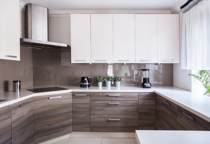Modern kitchen with white cabinets, representing custom cabinet building services in Annapolis, MD.