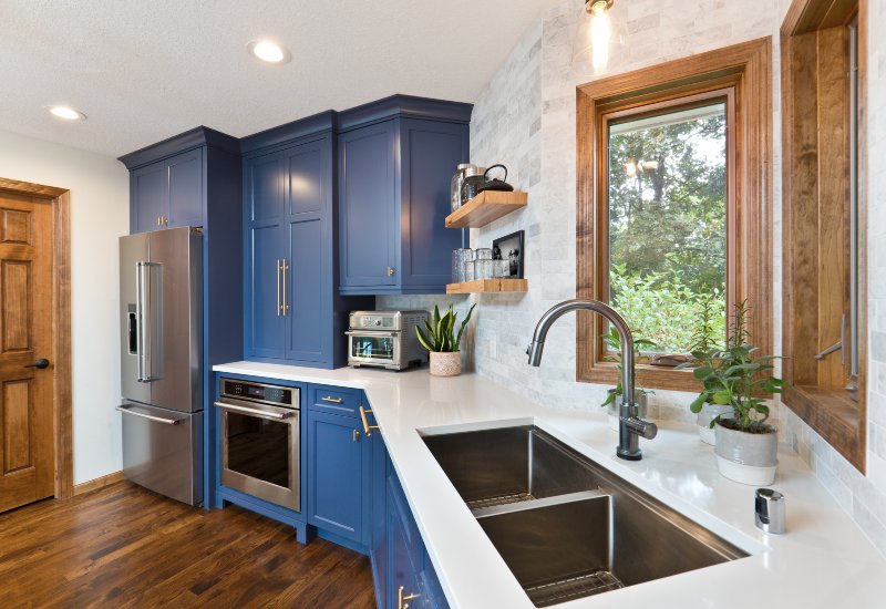 A modern kitchen featuring blue cabinets, showcasing custom remodeling in Annapolis, MD.